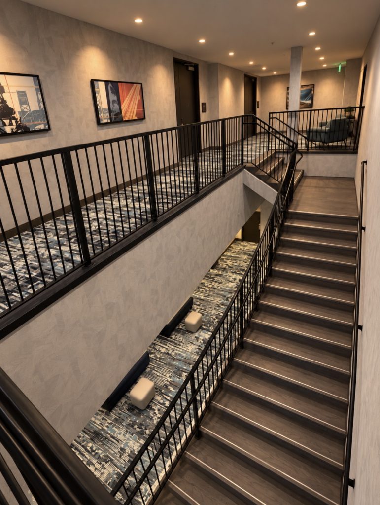 Interior stairwell and upper-level metal railings at Cambria Hotel Jacksonville